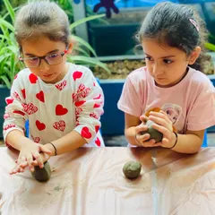 Two friends working together, completely focused on their clay Ganesha idols. These workshops are not just about art; they're about collaboration, concentration, and celebrating culture.