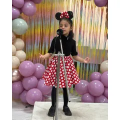 Dressed as Minnie Mouse, this little star performs her piece with charm and personality, bringing a beloved character to life.