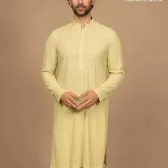 A full-length view of the pastel woven kurta, paired with simple white trousers. This showcases the effortless composition of the look, a study in poise, proportion, and the art of less.