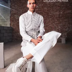 A full look of our white kurta set, featuring a vest embroidered with pearls to form a lotus motif. The look is defined by power and symmetry, with spun silk tailored to perfection.
