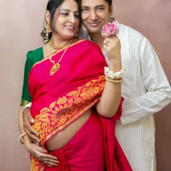 Celebrating your journey can also mean embracing tradition. This couple wanted to capture their joy in classic attire, and the vibrant color of her saree beautifully highlighted her pregnancy glow during this special maternity portrait session.