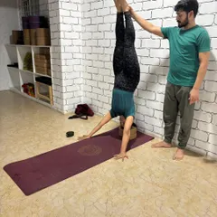 Using the wall for support is a great way to build confidence in inversions. I provide hands-on assistance to ensure proper alignment and safety in this supported headstand.