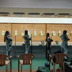 A line of our female athletes waiting for their turn to shoot during the state championship, showing focus and team camaraderie.