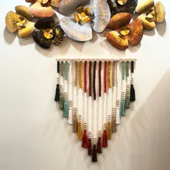 Here is my multi-tassel wall hanging styled with other metallic wall art. It shows how you can mix handcrafted textures with different decor styles to create a truly unique and personal space.