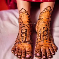 A lovely bridal feet design with jharokha (window) patterns. The stain is just beginning to develop, showing the beautiful orange color of fresh, natural henna.
