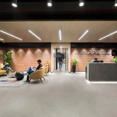 A wider view of the reception lounge, showing how we create different zones for waiting and informal meetings. The yellow sofa adds a pop of color against the neutral, textured background.