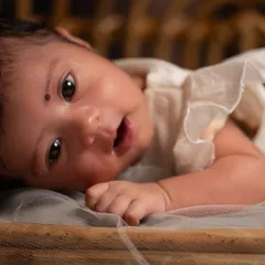 An awake and curious newborn making eye contact with the camera. I always take time to capture these moments of alertness, showing the baby's budding personality.