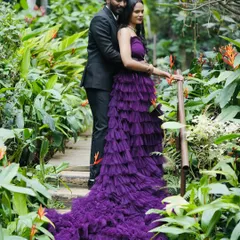 A classic pre-wedding couple pose in a lush garden. The bride-to-be is wearing one of my most popular rental gowns, a purple ruffle dress that photographs beautifully.