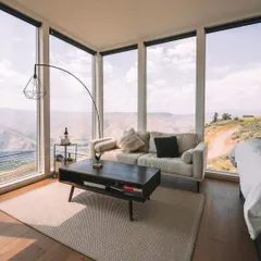 This container home interior shows how you can have a modern, comfortable living space with panoramic views. I use large glass windows to bring the beauty of the outdoors right into your home.