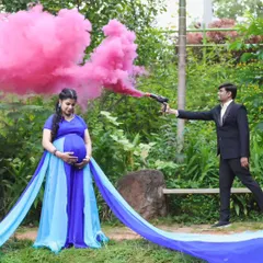 A fun and creative gender reveal shot during a maternity session. I provide props like color smoke guns to add an element of surprise and excitement to your photos.