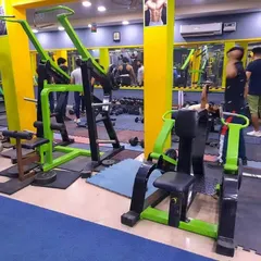 Our machine area is equipped for targeting every muscle group. This photo shows our chest press and lat pulldown machines, which are great for building upper body strength safely and effectively.
