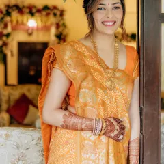 For her Mandvo ceremony, we opted for an elegant and traditional look. The makeup is clean and radiant, complementing her beautiful orange saree.