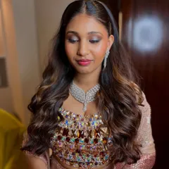 A detailed shot of the reception glam look. The soft shimmer on the eyes catches the light beautifully, paired with a glassy skin finish for that perfect evening glow.