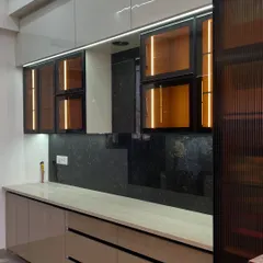 Another angle of the same kitchen, highlighting the handleless drawers and the fluted glass pantry door on the right, which adds a beautiful textural element.