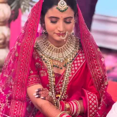 For my North Indian brides, I love creating these timeless, royal looks. This bride wanted a classic red lehenga look, and we focused on creating a luminous base with defined eyes and a bold lip that perfectly complemented her grand attire for the wedding ceremony.