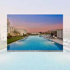 The expansive swimming pool at the Courtyard by Marriott, Gorakhpur, set against a beautiful sunset. The pool area is designed as a key recreational feature of this 7.5-acre lakeside property.