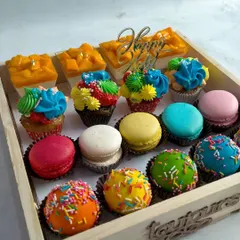 A colorful tray of my Holi-themed desserts, including vibrant macarons, sprinkle-covered cake balls, and mini mango cheesecakes. It's a sweet way to celebrate the festival of colors.