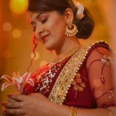 A different angle from the festive shoot, with the model holding a lily. This adds a soft, romantic element to the portrait.