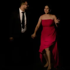 I designed this vibrant red cocktail dress for a client's pre-wedding festivities. The dress features a modern, asymmetrical high-low hemline and delicate spaghetti straps. The dark, moody lighting of the shoot makes the red color pop.