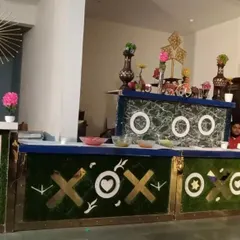 A custom-designed counter with playful "XOXO" and faux grass detailing. This is an example of how I can create a fun and thematic food station for a more casual company party or team event.