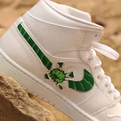 Hulk smash! This was one of my most challenging projects. I painted the Hulk breaking through the Nike swoosh on these Air Jordan 1s, which required careful alignment to create the 3D effect.