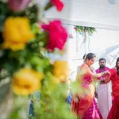 A guest is being helped during the wedding ceremony, a small act of kindness captured through a beautiful floral frame. We look for stories everywhere.
