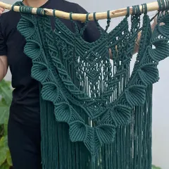 I call this design 'Heer'. It's a large, 42-inch long tapestry made with beautiful dark green cotton cord. The hand-knotted patterns are very intricate, especially the 3D-effect border, giving it an outstanding look.