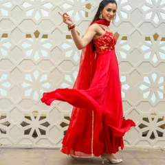 A full-length shot showing how the makeup and outfit work together. The makeup is bold enough to stand out in a dynamic, joyful pose against the intricate background.
