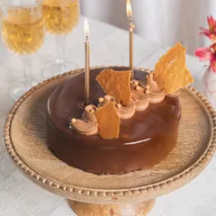 Our Hazelnut Praline cake, decorated with candles and ready for a New Year's or birthday celebration.