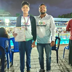 Congratulations to Shaswat Singh for securing a bronze medal in the 50m Backstroke at the NRJ State Swimming Championships. This picture captures the proud moment with his coach by the poolside.