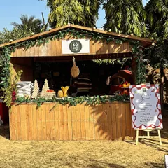 My humble wooden kiosk decorated for a festive event at Republic of Zoofari. The warm wood and holiday garlands create a welcoming and cozy atmosphere for serving hot pies.
