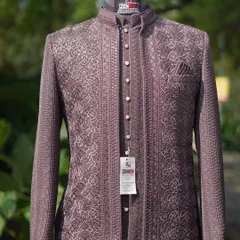 A new era of Jodhpuri elegance. This piece in a contemporary mauve-brown features intricate, geometric self-embroidery, offering a look that is modern, minimal, and bold.