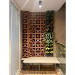 We created this green corner using a terracotta jali screen and a vertical garden. It’s a perfect example of how we bring natural elements and traditional materials into modern homes.