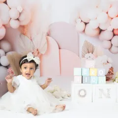 Celebrating one year with a beautiful pastel balloon setup. These milestone sessions are designed to be soft, dreamy, and perfect for a first birthday.