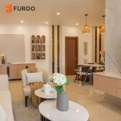 This view showcases the open-concept design, connecting the living room to the dining area in the background. We used a consistent color palette and materials like marble and wood to create a harmonious and flowing space.