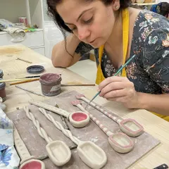 Another shot of a student absorbed in painting her unique, handmade spoons. Workshops are a wonderful way to de-stress and connect with your inner artist.