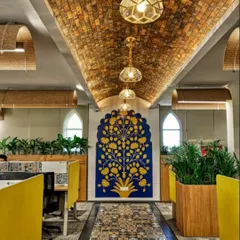 At the Miles Education office, I executed a design that blends rich Indian tradition with modern functionality. This view showcases the vaulted brick ceiling, intricate floor tiles, and custom "tree of life" wall art, all working together to create an inspiring atmosphere for learning.