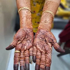 Another look at a gorgeous, mature henna stain. The color is even and dark throughout the design, from the intricate palms to the patterns on the arms.