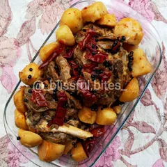 My Lamb Roast is a complete meal, featuring tender, bone-in lamb and soft potatoes roasted together. The meat is coated in a thick masala and garnished with whole red chilies and black peppercorns for a bold, aromatic flavor.