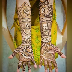 I specialize in personalizing your bridal mehandi. Here, I incorporated the groom's initial 'A' and a pair of elegant peacocks, which symbolize beauty and grace in Indian culture.