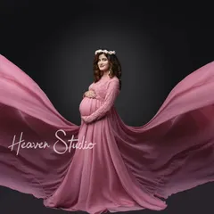 This elegant pink gown with lace sleeves and a flowing train is perfect for creating classic, graceful portraits. The fabric moves beautifully for those stunning motion shots.