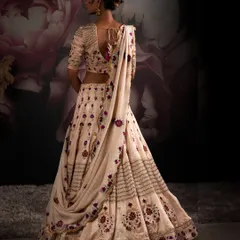 The back of a bridal lehenga is just as important as the front. This view showcases the delicate draping and deep back design, complete with traditional tassels, ensuring elegance from every angle.