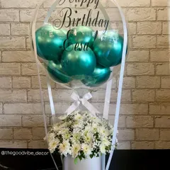 A beautiful birthday Bobo Box created for Eesa. This piece combines fresh white chrysanthemums with shiny teal balloons inside a personalized clear bubble, all set in a clean white box.