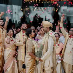 A royal affair with a gold-themed wedding. This shot captures the couple surrounded by family under a shower of petals, showcasing the grandeur of a destination wedding.