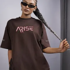 A close-up shot focusing on the branding and attitude. The model's confident expression, braids, and sunglasses complete the look, making this a powerful image for a brand campaign.