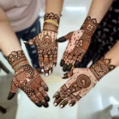 A showcase of coordinated mehandi for the bride tribe. Each hand has a unique yet complementary design, featuring elephants, peacocks, and floral patterns.