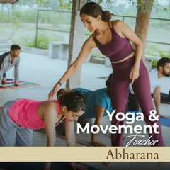 In my workshops, I provide gentle, hands-on guidance to help you find correct alignment and deepen your practice safely. Here, I am assisting a student in a group setting, fostering a supportive space for everyone to grow.
