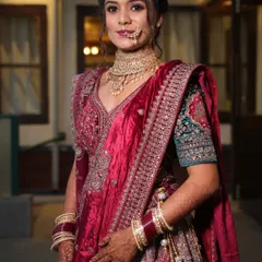 A beautiful portrait of the reception bride. The soft lighting highlights her glowing skin and the intricate details of her velvet lehenga.