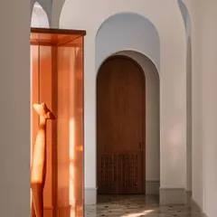 This wooden sculpture, housed in a deep amber glass case, is the 'pièce de résistance' of the main galleria. We placed it strategically to break the circulation spine and spark conversation, proving that art can add immense value and narrative to a space.
