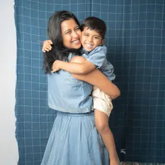 A big, happy hug full of laughter. This candid shot captures the pure joy and affection between a mother and her child, making it a perfect memory from their family photoshoot.